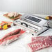 A Weston Pro vacuum packaging machine sealing meat.