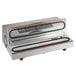 A Weston vacuum packaging machine on a counter with a clear lid.