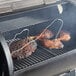 Two pieces of meat being cooked on a Backyard Pro wood-fired pellet grill.