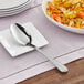 A plate with a spoon on it and food.