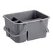 A gray plastic cleaning caddy with four compartments and a handle.