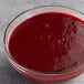 A bowl of Les Vergers Boiron Morello Cherry fruit puree on a table.