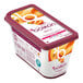 A container of Les Vergers Boiron Apricot 100% Fruit Puree with a purple lid next to a spoon.