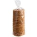 A plastic bag with a red handle full of round brown Lancaster Stroopies Caramel Stroopwafel cookies.