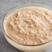 A bowl of oatmeal with Les Vergers Boiron Banana Fruit Puree on a table.