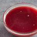 A glass bowl of Les Vergers Boiron Pomegranate Fruit Puree.