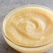 A bowl of Les Vergers Boiron Pear puree on a table.