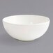 A Front of the House European White porcelain ramekin on a gray surface.
