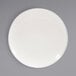 A Front of the House European white porcelain plate with an embossed spiral design.