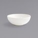 A Front of the House Catalyst European White porcelain bowl on a gray surface.