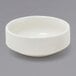 A Front of the House European White porcelain ramekin on a gray surface.