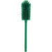 A close-up of a Carlisle Sparta green bottle cleaning brush with bristles.