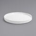 A Front of the House Soho bright white porcelain plate with a raised rim on a gray surface.