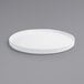 a white round plate on a gray background