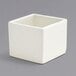 A Front of the House European white square porcelain ramekin.