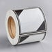 A roll of white and black stickers with a white background.