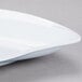 A GET San Michele white platter with a curved edge.