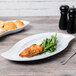 A GET San Michele white platter with chicken and green beans on it.