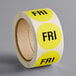 A roll of yellow Lavex Friday inventory day labels with black text.