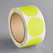 A roll of yellow and white round stickers with white matte paper.