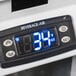 A digital display on a Beverage-Air glass door merchandiser.