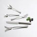 Arcoroc stainless steel tasting spoon on a white surface.
