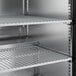 A stainless steel Hoshizaki undercounter refrigerator with shelves.