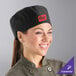 A woman wearing a black Uncommon Chef skull cap with mesh top.