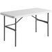 A white rectangular table with black legs.