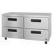 A silver metal cabinet with black drawers on wheels.
