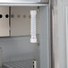 A thermometer inside a Beverage-Air refrigerated sandwich prep table.