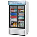 A Turbo Air white refrigerated merchandiser with drinks inside.