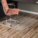 A clear rectangular Alera office chair mat under a chair in a room.