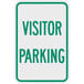 A white and green sign with green text that says "Visitor Parking"