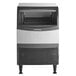 A black and silver Scotsman undercounter ice machine with a gray top and a door open.