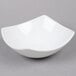 An American Metalcraft white stoneware bowl on a gray surface.