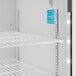 A white Hoshizaki glass door refrigerator with shelves and blue lights.