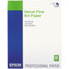 A white box with green text for Epson Velvet Fine Art Paper - 25 sheets.