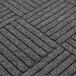 A close up of a charcoal diamond patterned Guardian EcoGuard floor mat.