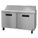 A stainless steel refrigerated counter with two doors.