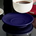 A cup of coffee on a Tuxton cobalt cappuccino saucer.