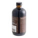 A close-up of a Nielsen-Massey Pure Vanilla Extract bottle with a brown label.