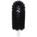 A black round brush with a white handle.
