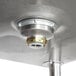 Advance Tabco stainless steel leg mounted utility sink with a metal drain.