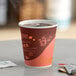 A close-up of a Choice coffee cup full of brown liquid.