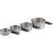 A group of OXO stainless steel measuring cups on a counter.