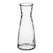 A Front of the House Drinkwise clear plastic carafe with a hammered design.