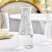 A Front of the House Drinkwise clear plastic carafe filled with a clear liquid on a table
