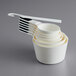 A stack of white OXO Good Grips measuring cups.
