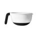 A white OXO measuring cup with a black handle and measurements.